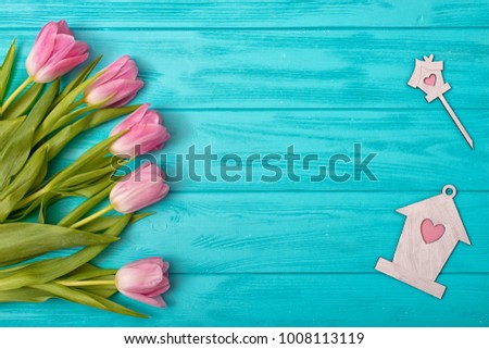 Valentine's Day background with bouquet of tulips and holiday decor.