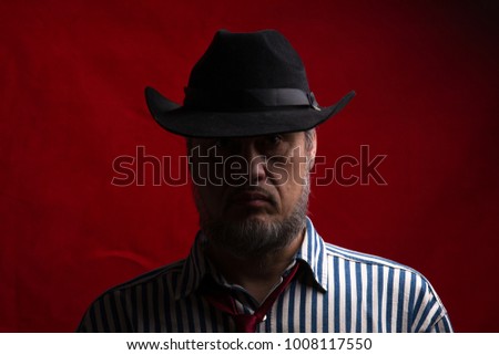male cowboy portrait on a red background