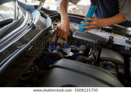 Engine engineer is replacing car battery because car battery is depleted. Concept car maintenance 