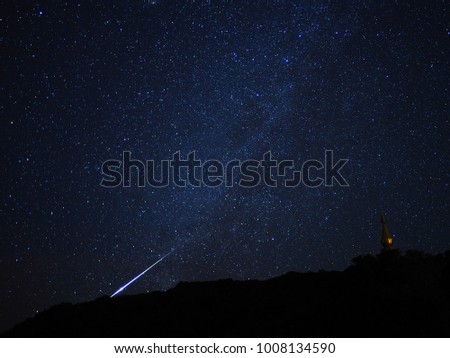 Make a wish with the long beautiful blue geminid meteor shower . Northern of thailand. Picture with noise.