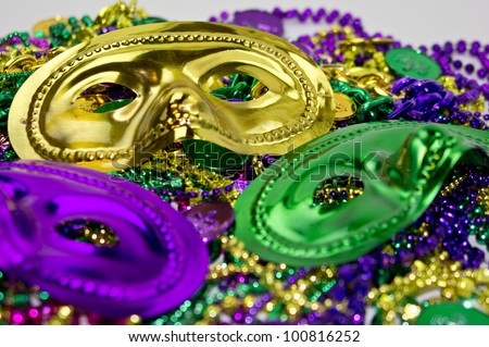 Mardi Gras masquerade mask on a background of colorful Mardi Gras Beads