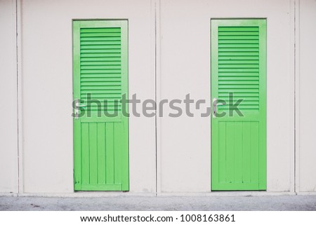 geometrical view of tho green windows with white frames on a white wall