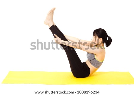 attractive young asian woman doing yoga post on white background in white room studio.