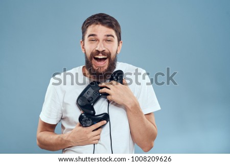  technology, joysticks, joyful man on a blue background                              