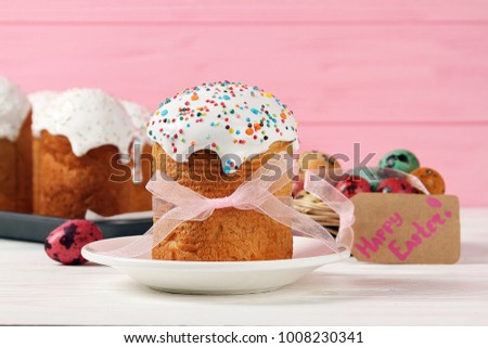 Traditional Easter cake on a plate on a pink background