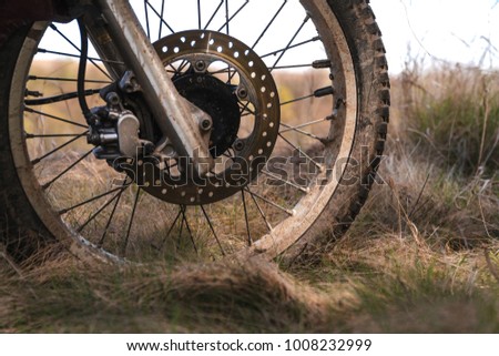 Close-up of muddy rear wheel of dirt bike, details