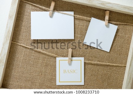 Empty Three Photo Frames on Rope inside the wooden frame