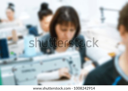 people work in a sewing workshop. Studio. Blurred Background