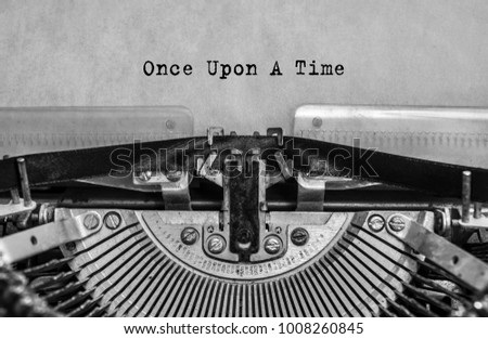 once upon a time, the text is written with old typewriter, close-up. Vintage, antiques Royalty-Free Stock Photo #1008260845