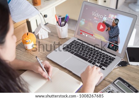 Online video tutorial concept.Female using laptop or pc on wooden table Royalty-Free Stock Photo #1008267685
