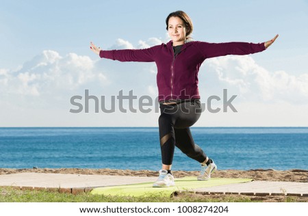 young european girl exercising on exercise mat outdoor
 