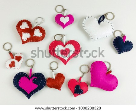 Homemade valentine's red heart and paper boxes on white background -  top view