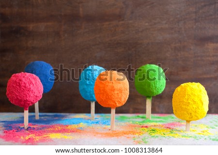 Bright colours in shapes of trees or posicles for Indian holi festival. Colorful gulal (powder colors) for Happy Holi. Royalty-Free Stock Photo #1008313864