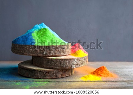 Bright colours on sawed wood for Indian holi festival. Colorful gulal (powder colors) for Happy Holi with copy space. Royalty-Free Stock Photo #1008320056