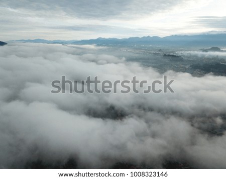 Aerial view of sky and city on the cloudy day. Selective focus and crop fragment.