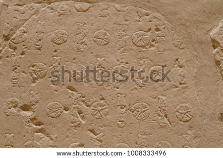 Texture of stones in Egyptian temples. Hieroglyphics writings on ancient walls in a pharaohs old temple