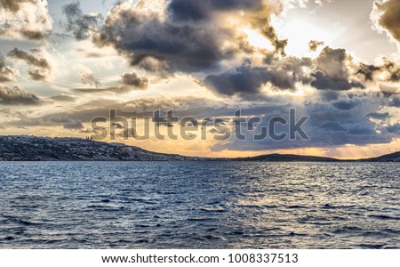 Amazing sunset with town on background and colorful cloudy sky, Malta.