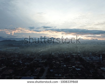 Aerial view of sky and city on the cloudy day. Selective focus and crop fragment.