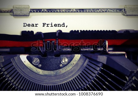 Text Dear Friend written with the typewriter on white sheet Royalty-Free Stock Photo #1008376690