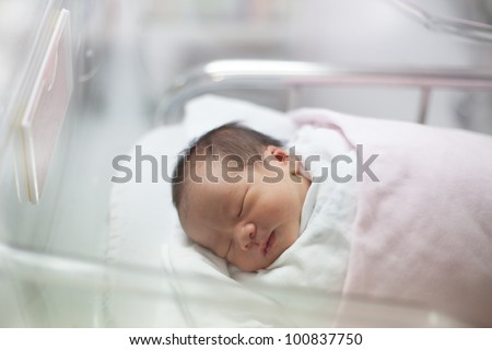 new born infant asleep in the blanket in delivery room Royalty-Free Stock Photo #100837750
