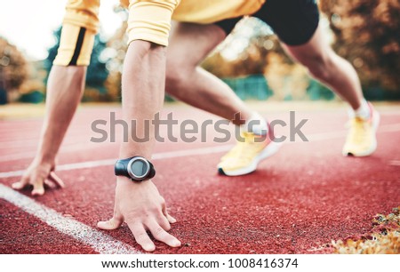 Runner in starting position, closeup photo. Sport, fitness, athletics concept