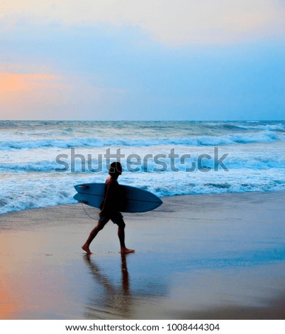 Dreadlocks surfer on the beach with surfboard . Bali island