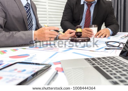 Colleagues are discussing issues related to lawsuits and counseling to fight lawsuits in court. Royalty-Free Stock Photo #1008444364