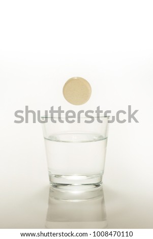 efervescent tablet dissolving in a glass of water