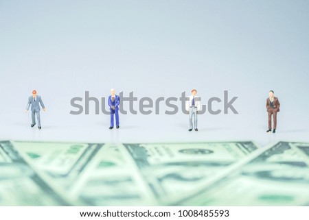 Miniature people : Businessman with bills. Business concept.