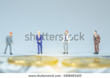 Miniature people : Businessman with golden coin and bills. Business concept.