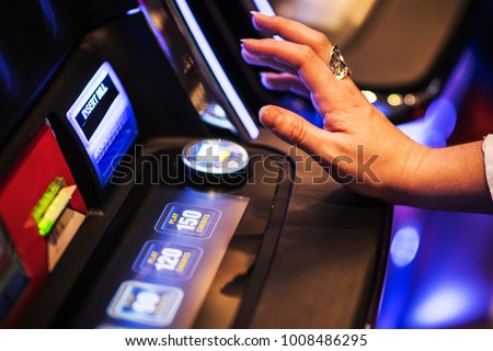 Ready For Slot Machine Spin. Gambling in the Casino Concept. Caucasian Woman Playing Game. Royalty-Free Stock Photo #1008486295