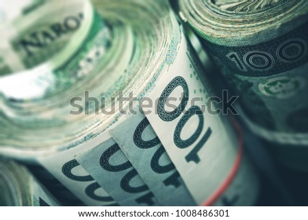 Rolled Polish Zloty Banknotes Closeup Photo. Polish Financial Concept.