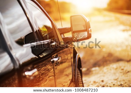 Pickup Truck Off Road Driving During Scenic Sunset. Heavy Duty Load Pulling on the Countryside Road. Royalty-Free Stock Photo #1008487210