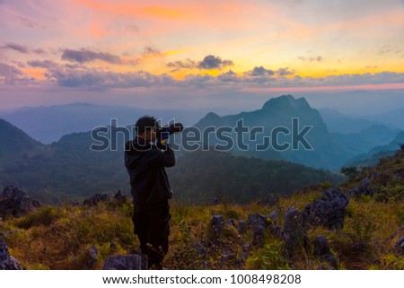 Outdoor photographer concept on the mountain  in the twilight
