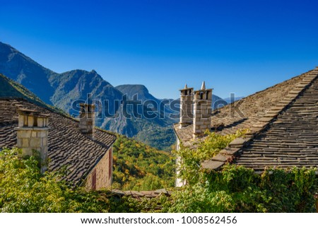 Spring colors and traditional architectural buildings at the picturesque mountainous village of Papigo, Epirus, Greece, Europe. Royalty-Free Stock Photo #1008562456