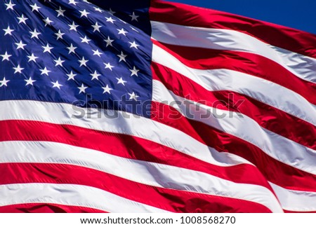 Perfect American Flag with perfect waves with a small corner of perfect blue sky. A patriotic national flag that stands for freedom
