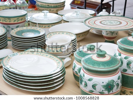 Collection of matching dishes for sale at a garage sale Royalty-Free Stock Photo #1008568828