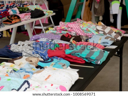 Colorful children's pajamas a suburban yard sale Royalty-Free Stock Photo #1008569071