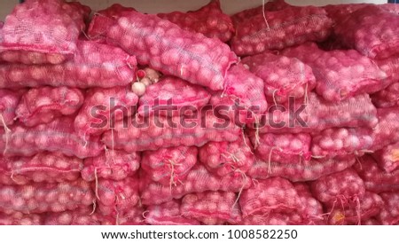 Onions in stored in netting for distribution to market. Royalty-Free Stock Photo #1008582250