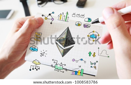 Ethereum with mans hands and a white notebook