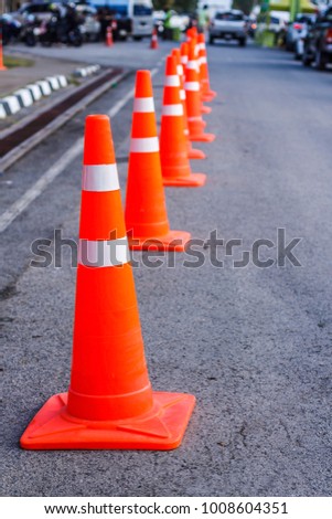 Orange traffic cones in the outdoors, alert, beware