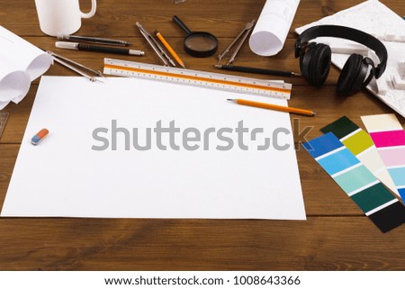 Decorator workplace with blank project, color swatches and tools, closeup, copy space