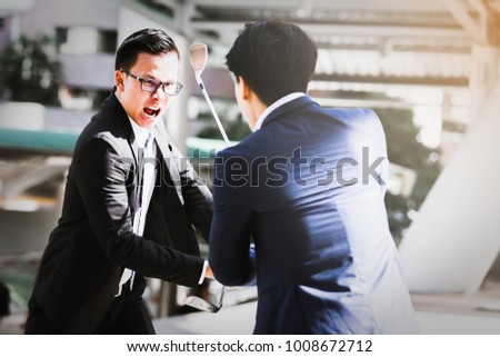 Asian businessman angry battle with golf background city. Business concept