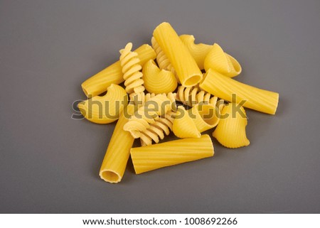 Different types of pasta isolated on grey