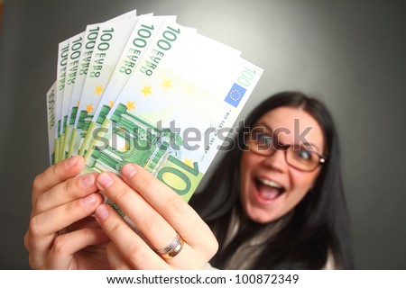 the girl the brunette wearing spectacles holds a lot of money
