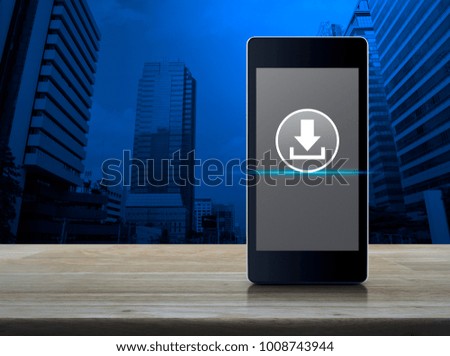 Download icon on modern smart phone screen on wooden table over office city tower, Business internet concept