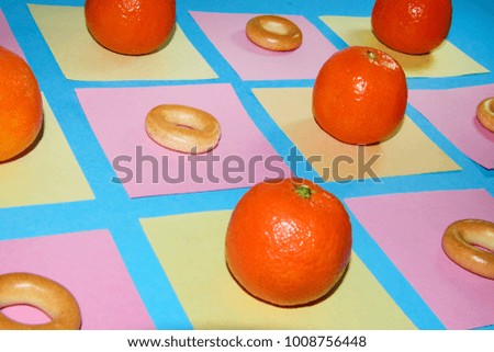 Bagels and oranges  on the table on colour note reminders papers