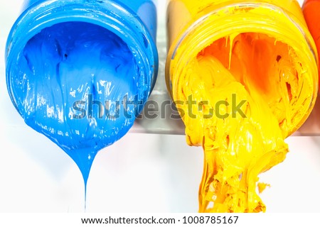 yellow blue and red colors of Plastisol ink on white table. Plastisol ink for print tee shirt and any fabric useful in tee shirt factory. yellow blue and red colors are primary color.