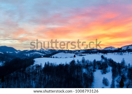 Natural Sunset Sunrise Over Field Or Meadow. Bright Dramatic Sky And Dark Ground. Countryside Landscape Under Scenic Colorful Sky At Sunset Dawn Sunrise. Sun Over Skyline Horizon. Warm Colours.