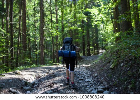 Hiking boy in forest following by drone